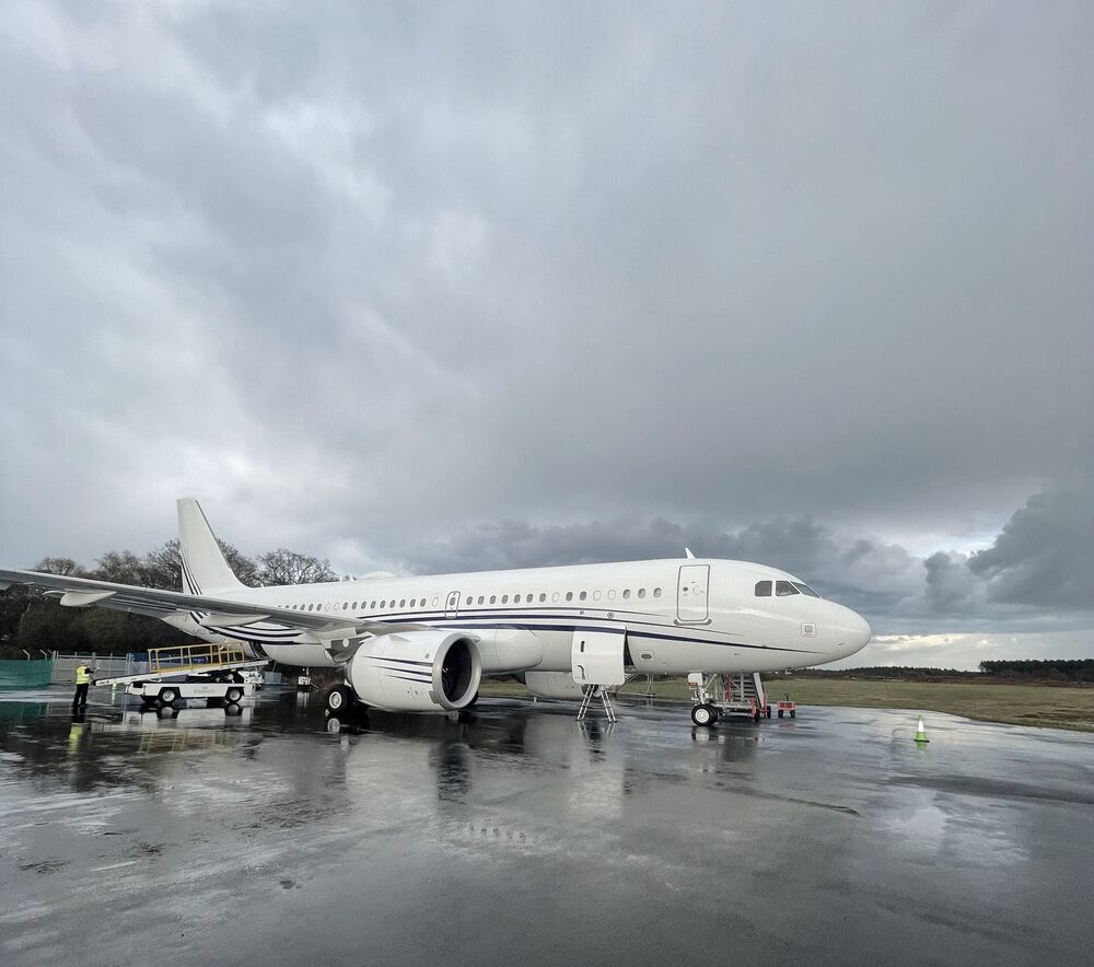 Airbus Corporate Jet on a wet apron under a grey sky