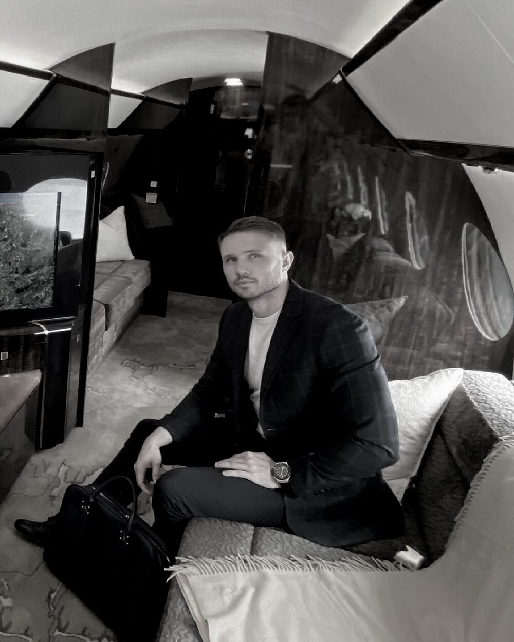 James Ison seated in a private jet cabin